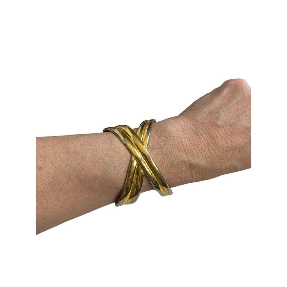 Gold toned cuff double crossed bracelet